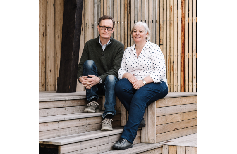 Richard and kate sitting on steps of their home